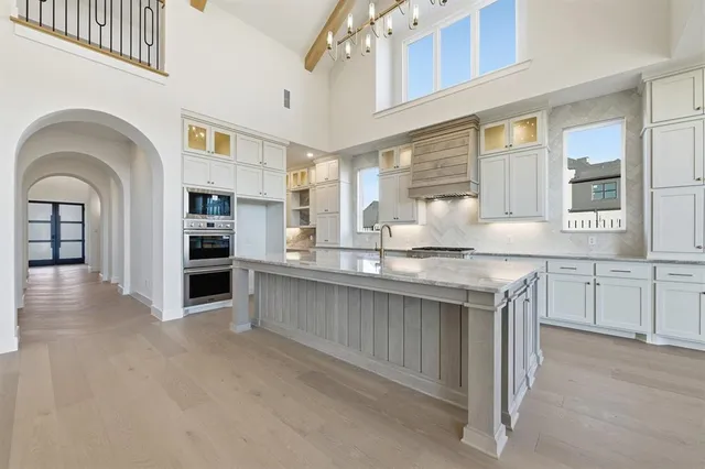 a kitchen with stainless steel appliances granite countertop a sink and cabinets