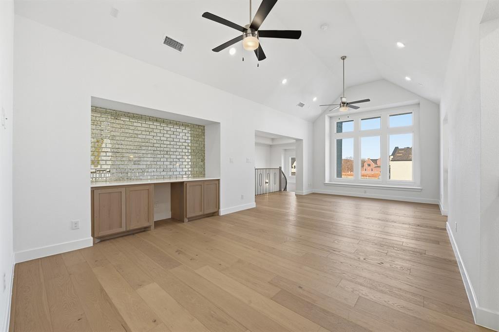 3700 Meander Way Prosper, TX 75078 - Photo 22 of 29 an empty room with wooden floor chandelier and windows