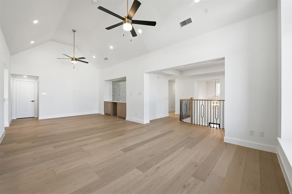 3700 Meander Way Prosper, TX 75078 - Photo 24 of 29 a view of empty room with wooden floor and ceiling fan