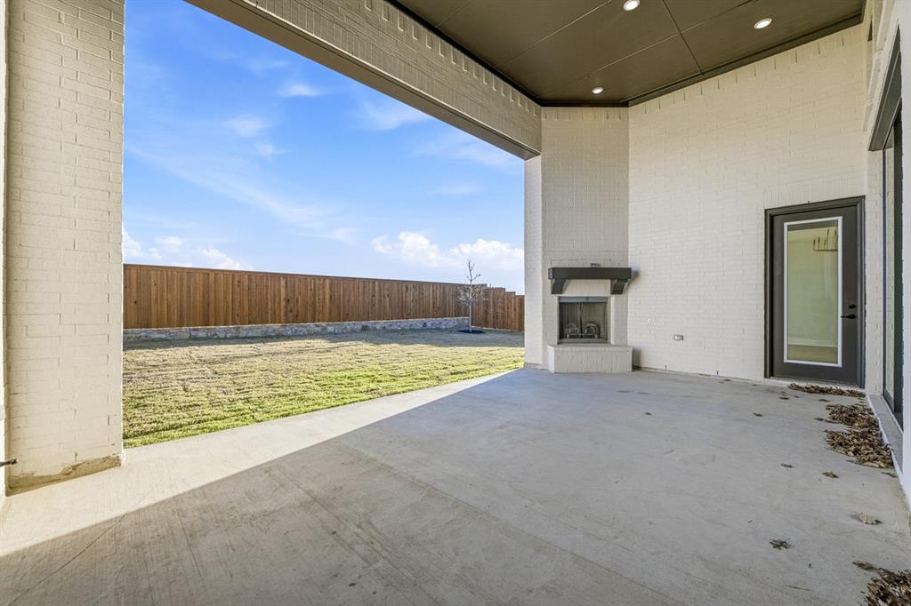 3700 Meander Way Prosper, TX 75078 - Photo 28 of 29 a view of an empty room with a fireplace and a window