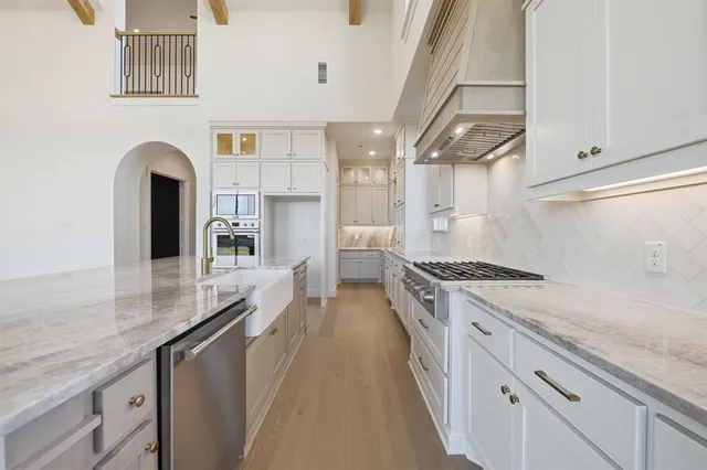 a kitchen with stainless steel appliances granite countertop a stove and a sink