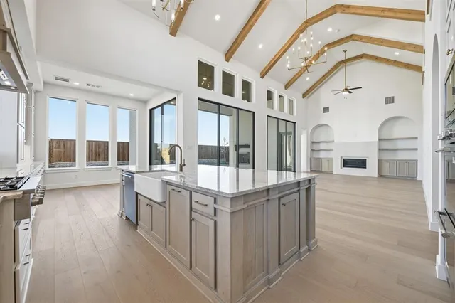 a very nice looking room with a large window and wooden floor