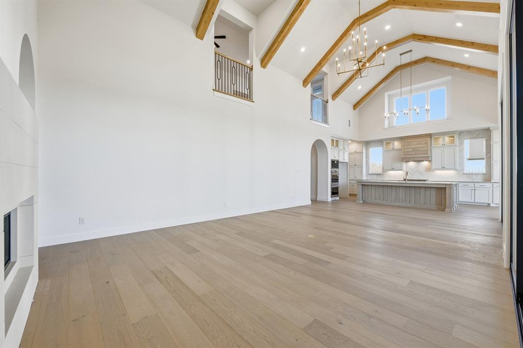 3700 Meander Way Prosper, TX 75078 - Photo 7 of 29 a view of a room with a wooden floor and a large window