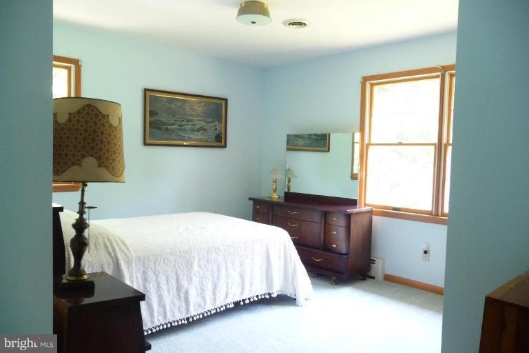 1130 Cox Road Huntingtown, MD 20639 - Photo 11 of 30 a bedroom with a bed and a window