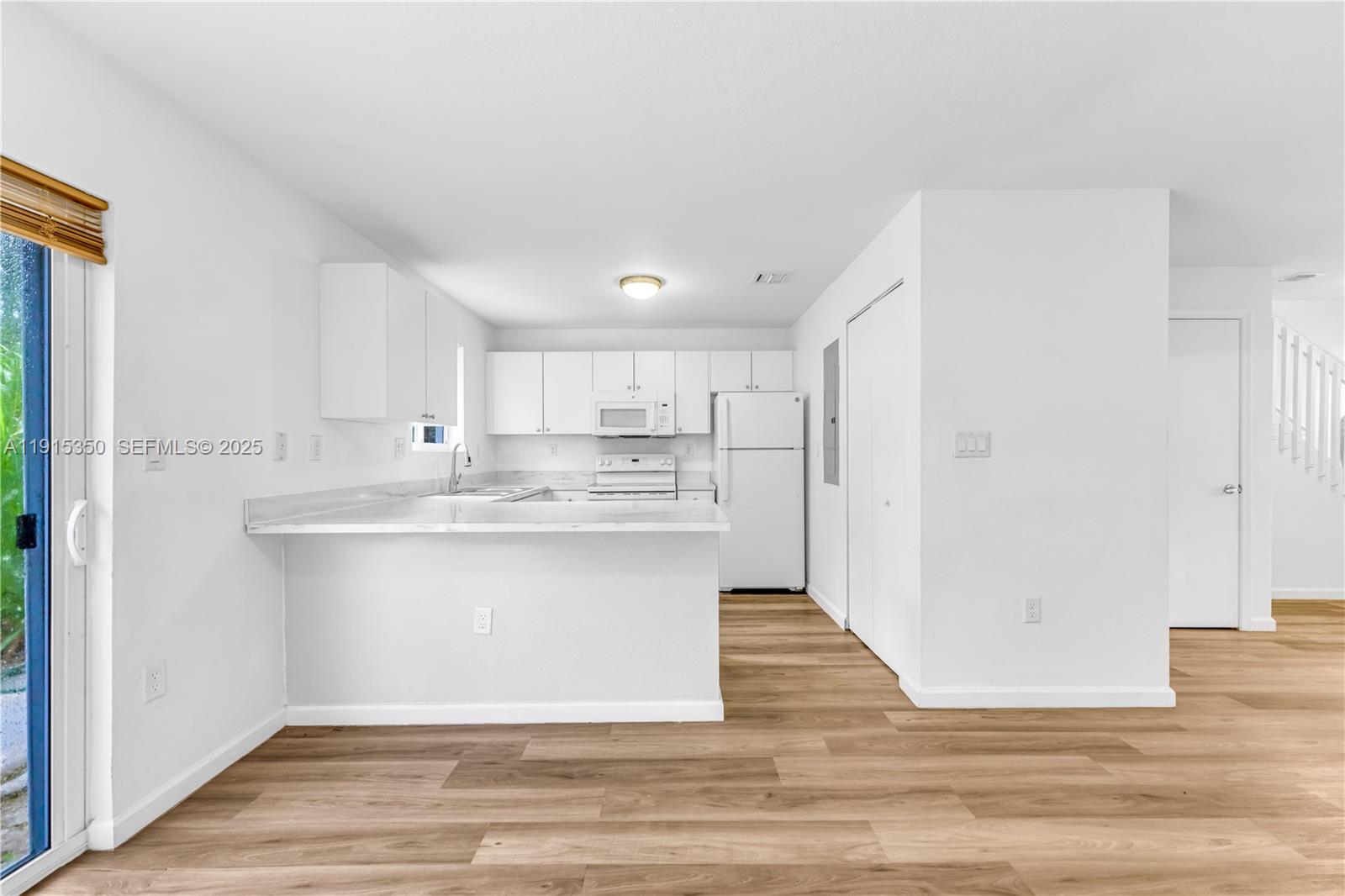 190 Southwest 3rd Court Florida City, FL 33034 - Photo 8 of 22 a view of kitchen with stainless steel appliances granite countertop white cabinets and window