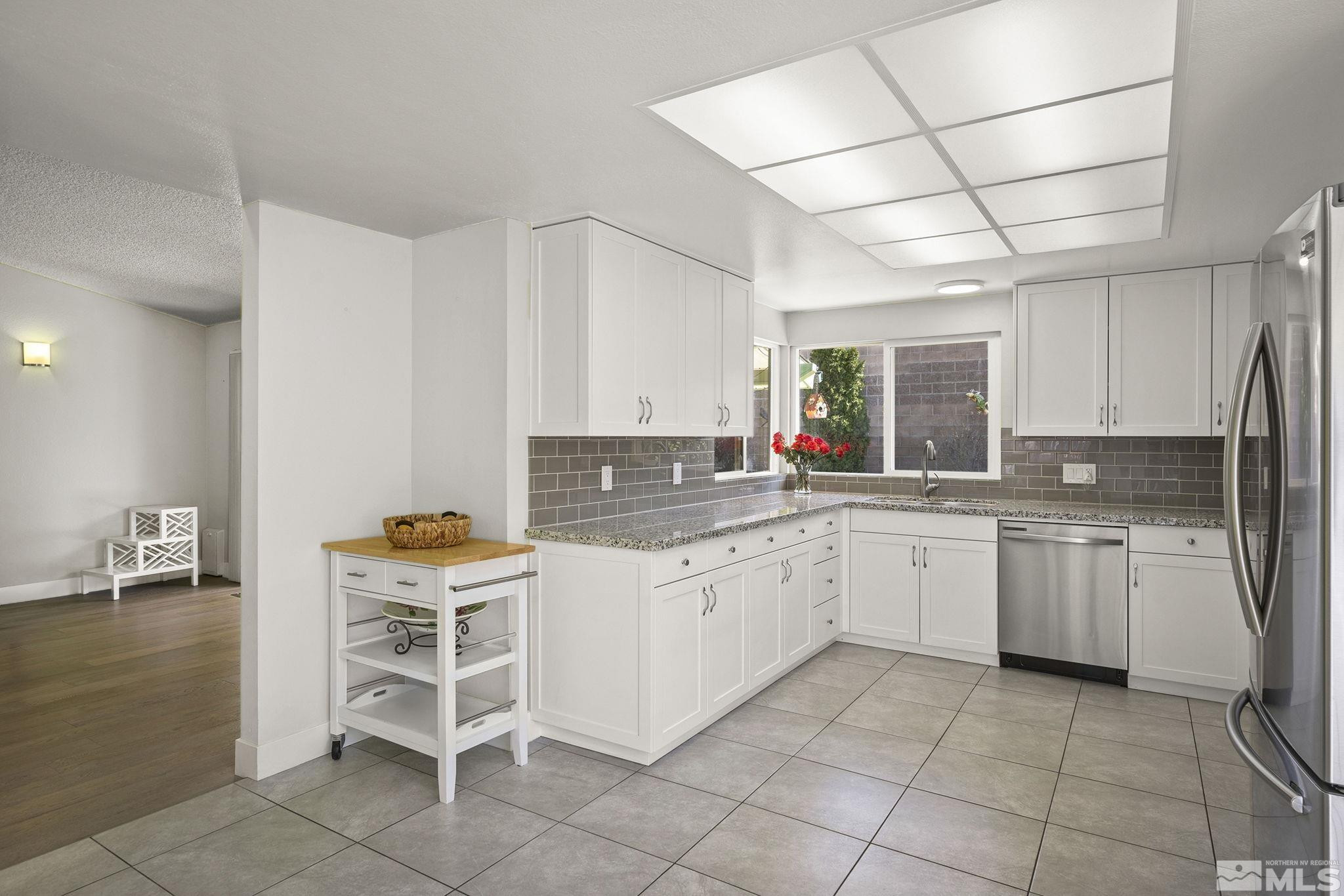 920 Pinebrook Road Reno, NV 89509 - Photo 11 of 40 a kitchen with a sink and chairs
