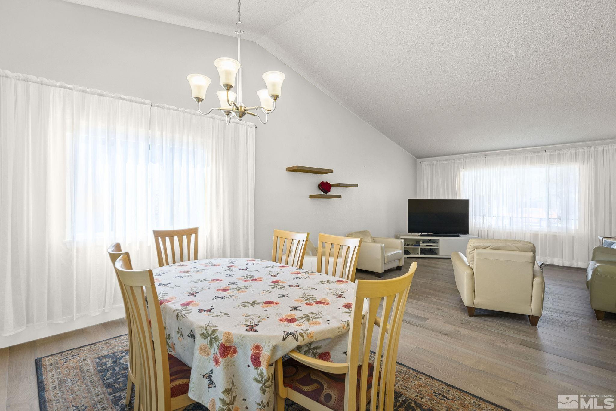 920 Pinebrook Road Reno, NV 89509 - Photo 16 of 40 a view of a dining room with furniture a chandelier and wooden floor