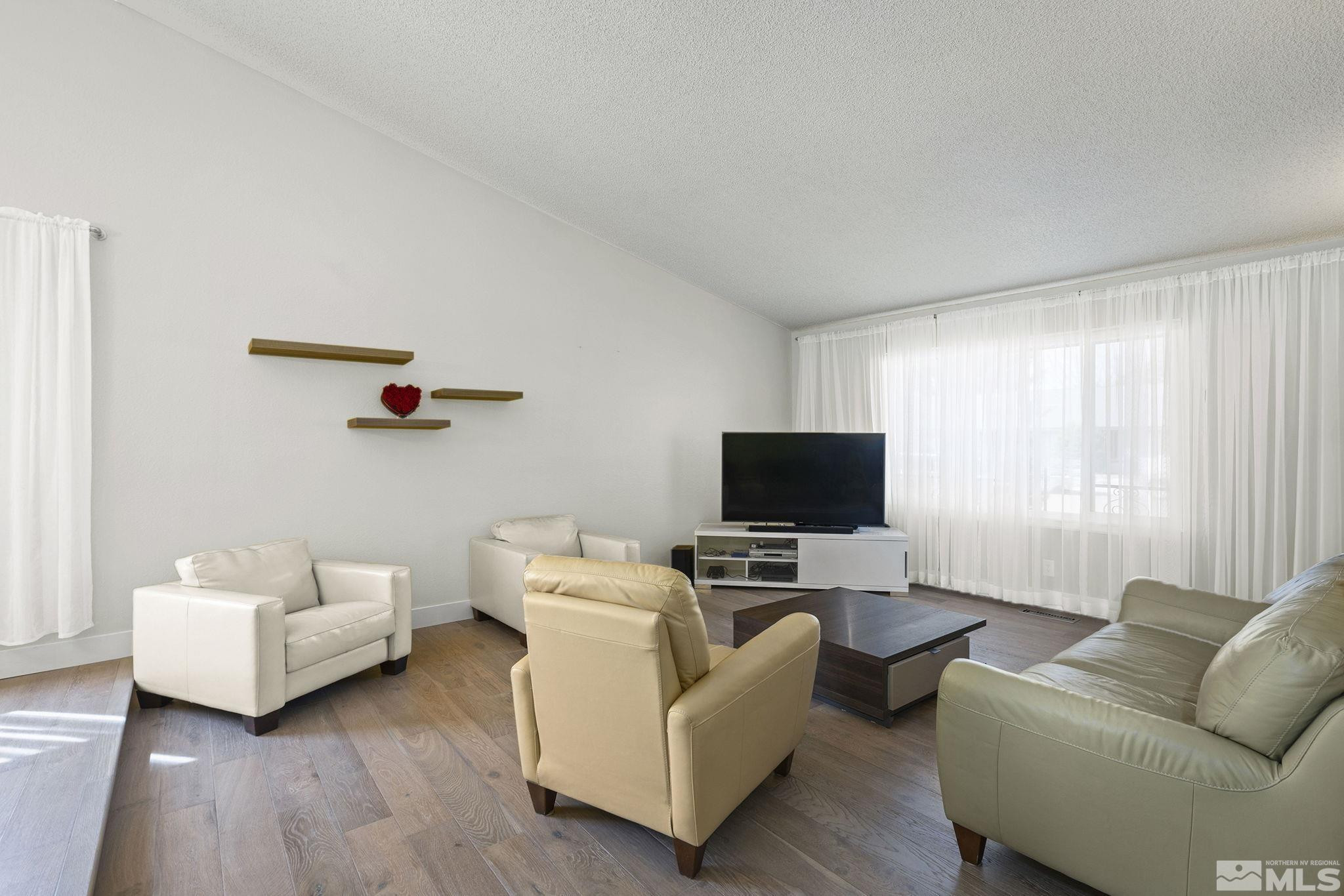 920 Pinebrook Road Reno, NV 89509 - Photo 21 of 40 a living room with furniture and a flat screen tv