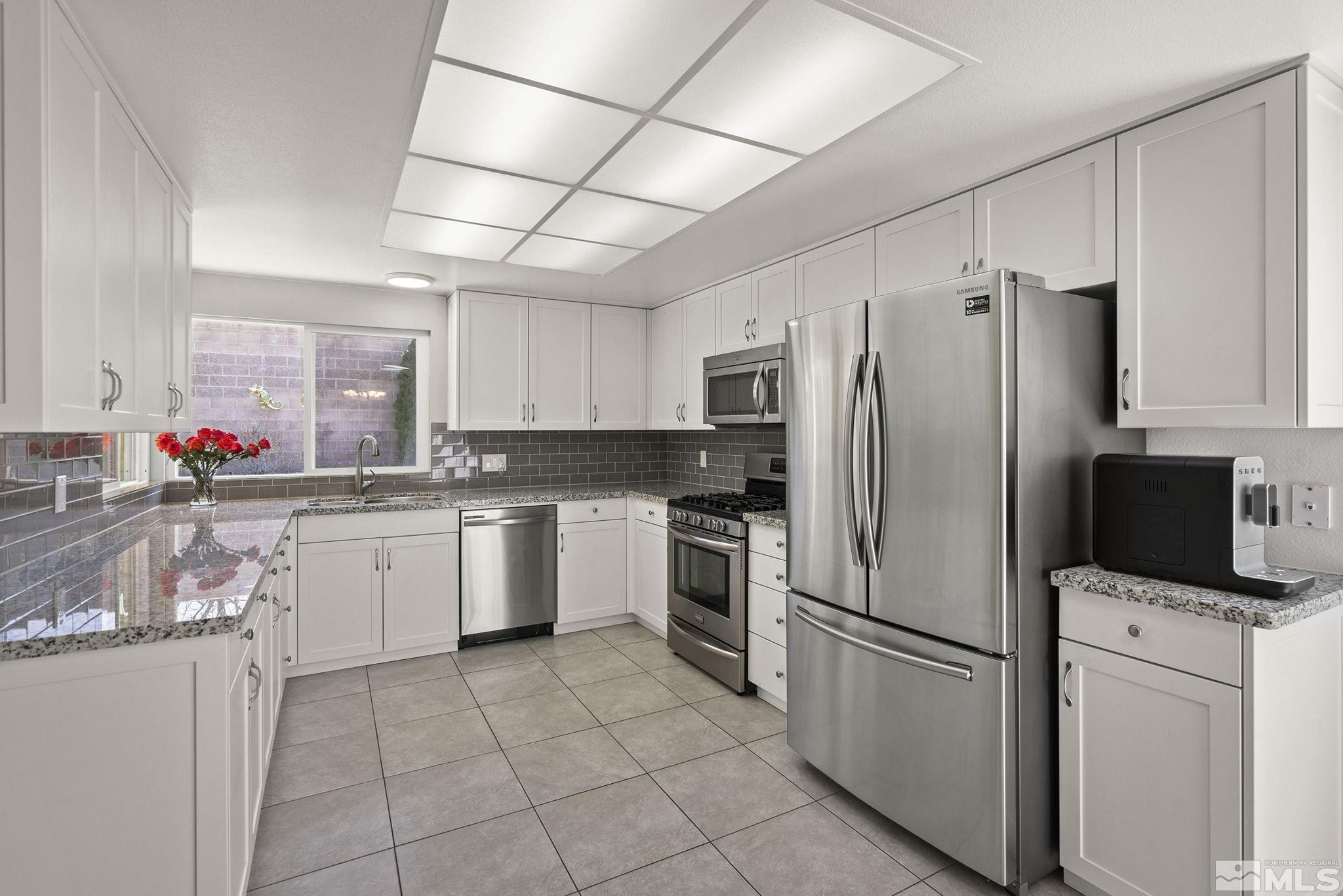 920 Pinebrook Road Reno, NV 89509 - Photo 10 of 40 a kitchen with a refrigerator sink and cabinets
