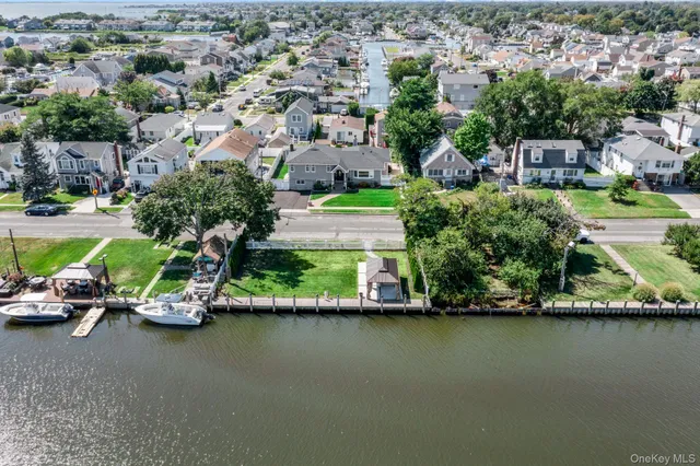 an aerial view of a house with a garden and lake view
