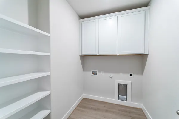 a view of a refrigerator with white cabinets