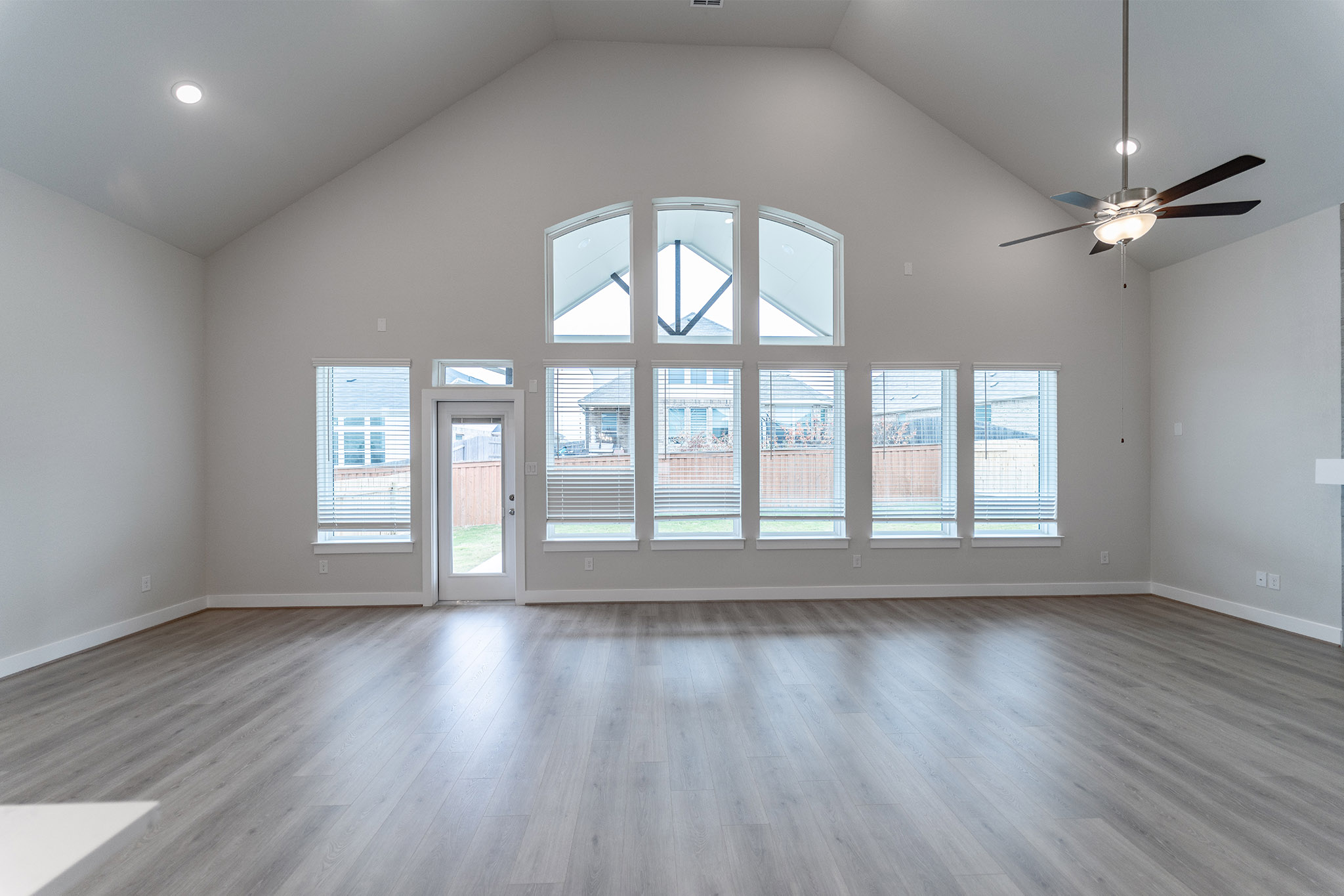 871 Cherrystone Loop Buda, TX 78610 - Photo 2 of 20 a view of an empty room with wooden floor and a window