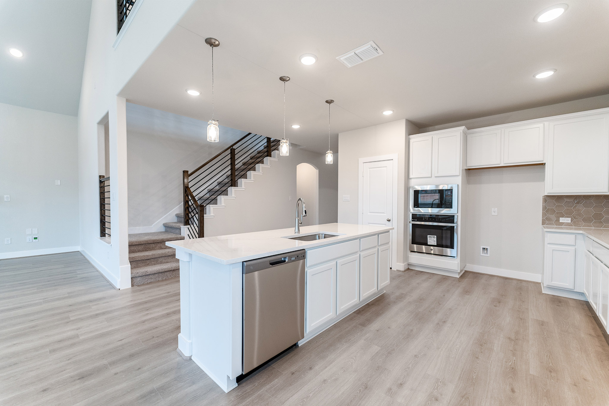 871 Cherrystone Loop Buda, TX 78610 - Photo 4 of 20 a large kitchen with stainless steel appliances a large counter top and a wooden floors