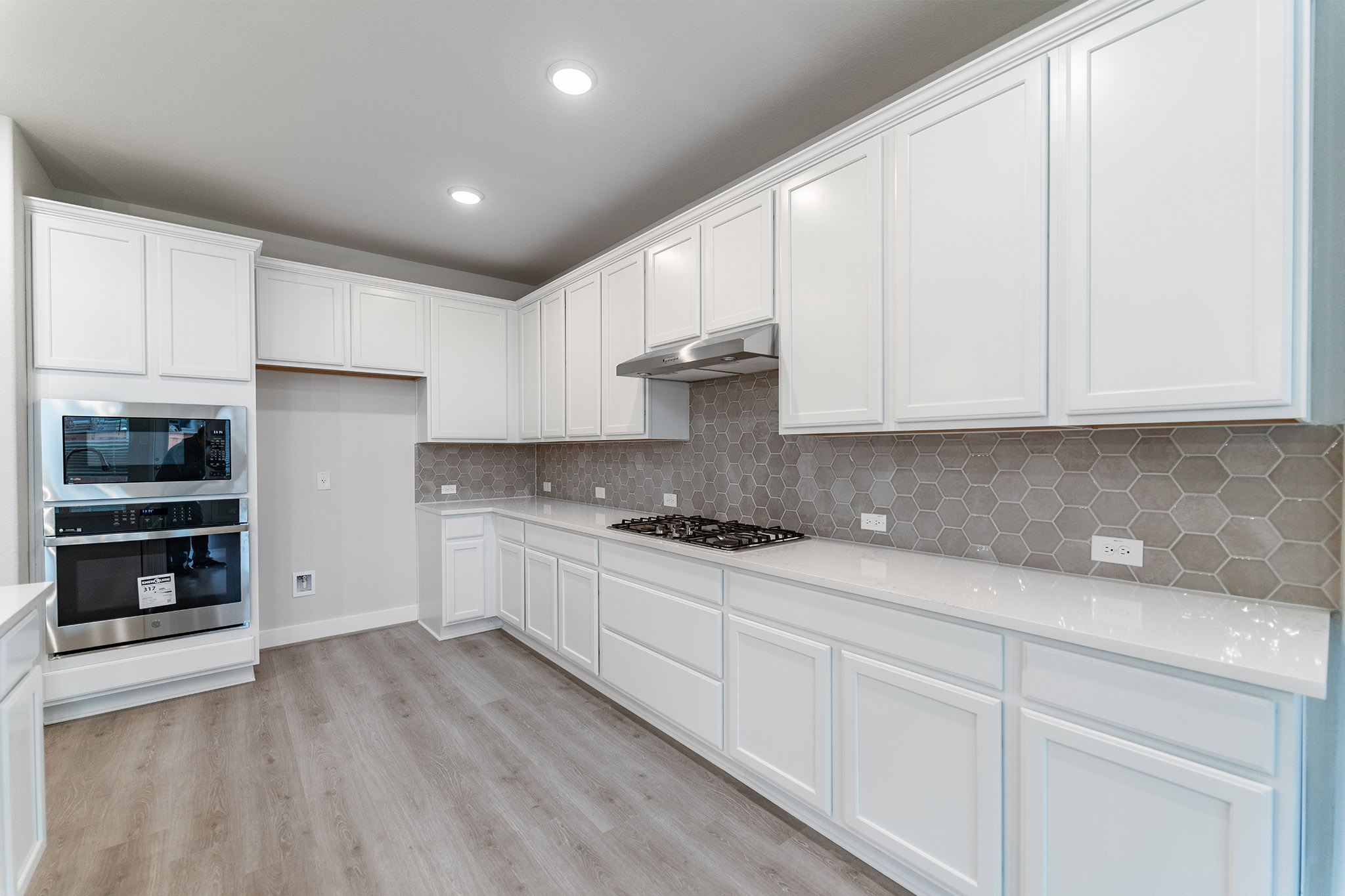 871 Cherrystone Loop Buda, TX 78610 - Photo 5 of 20 a kitchen with stainless steel appliances granite countertop a stove a sink and a refrigerator
