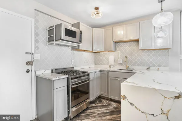 a kitchen with a stove sink and microwave
