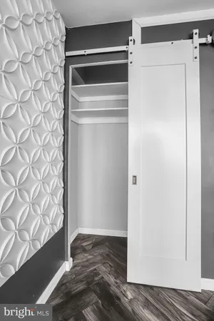 a view of walk in closet with wooden floor