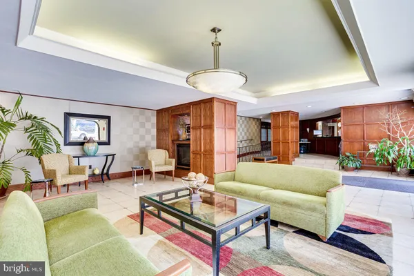 a living room with furniture a table and a chandelier