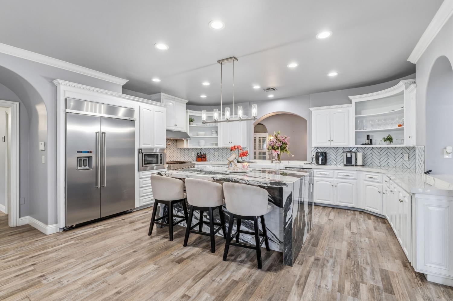 17703 El Camino Road Madera, CA 93636 - Photo 14 of 64 a kitchen with stainless steel appliances a dining table chairs stove refrigerator and cabinets