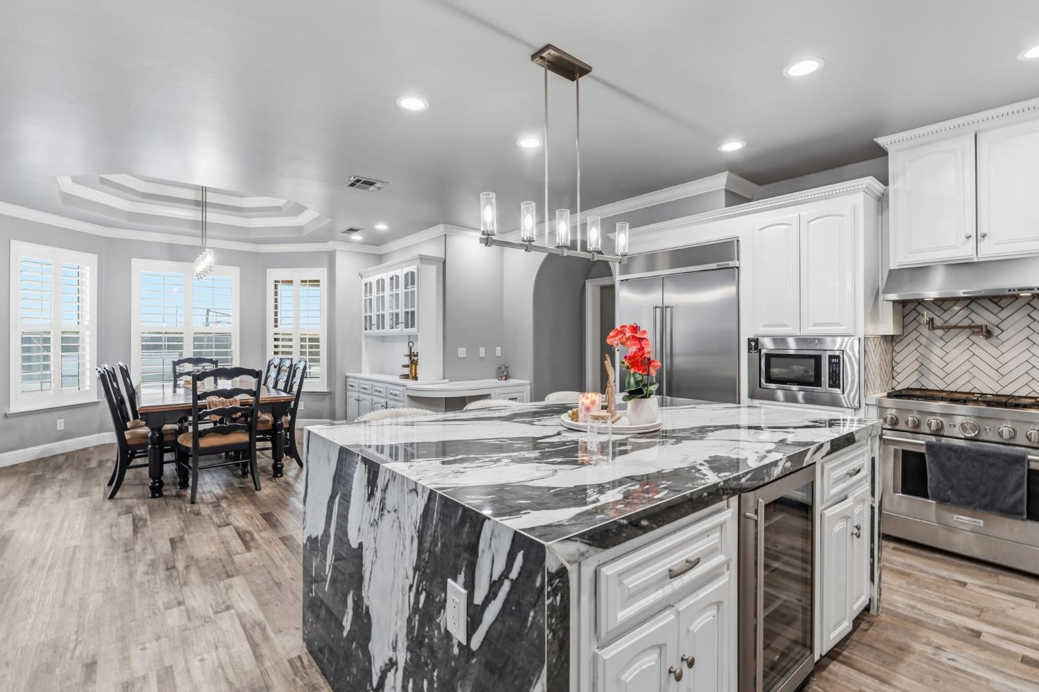 17703 El Camino Road Madera, CA 93636 - Photo 15 of 64 a kitchen with stainless steel appliances granite countertop a stove and a wooden floors