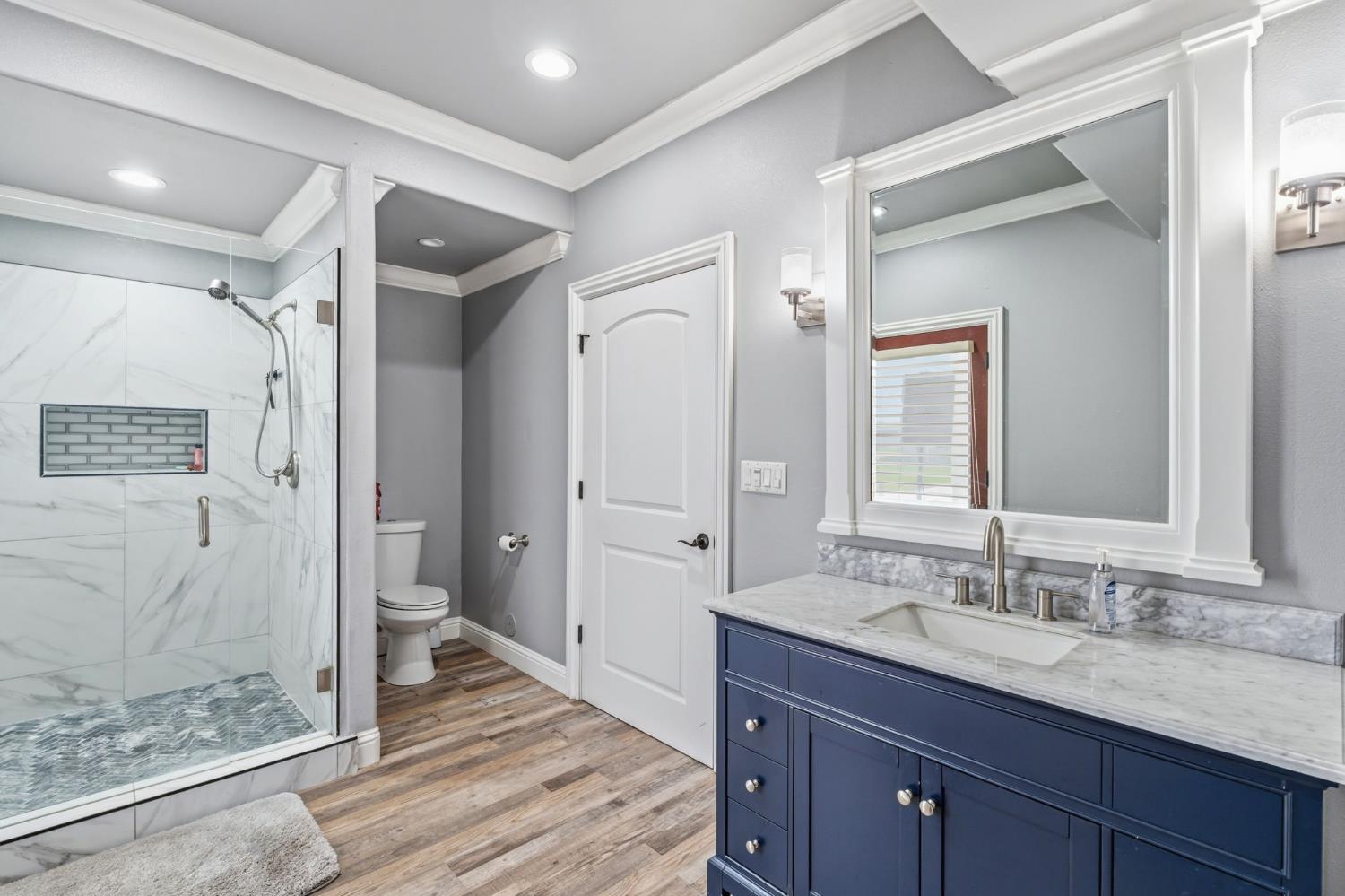 17703 El Camino Road Madera, CA 93636 - Photo 18 of 64 a spacious bathroom with a granite countertop sink mirror and shower