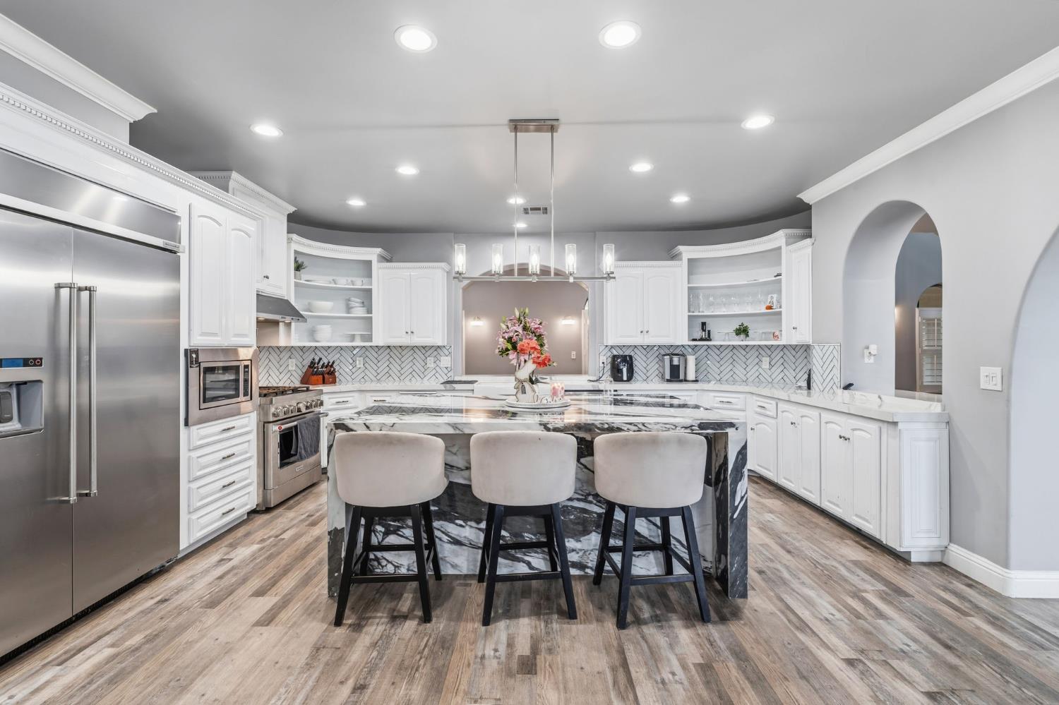 17703 El Camino Road Madera, CA 93636 - Photo 19 of 64 a kitchen with stainless steel appliances granite countertop a kitchen island hardwood floor and a sink