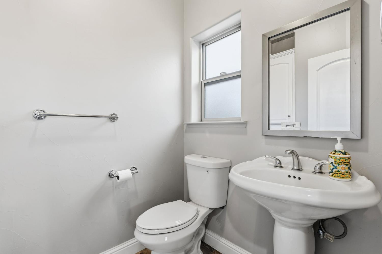 17703 El Camino Road Madera, CA 93636 - Photo 26 of 64 a white toilet sitting next to a bathroom sink