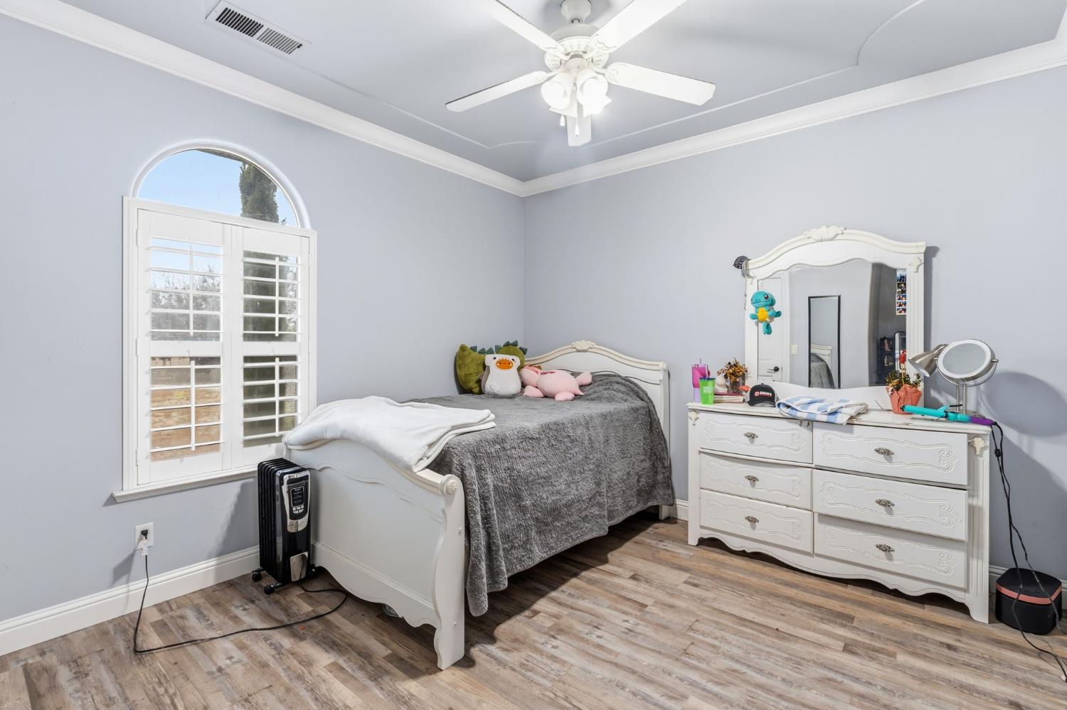 17703 El Camino Road Madera, CA 93636 - Photo 30 of 64 a bedroom with a bed and a chandelier