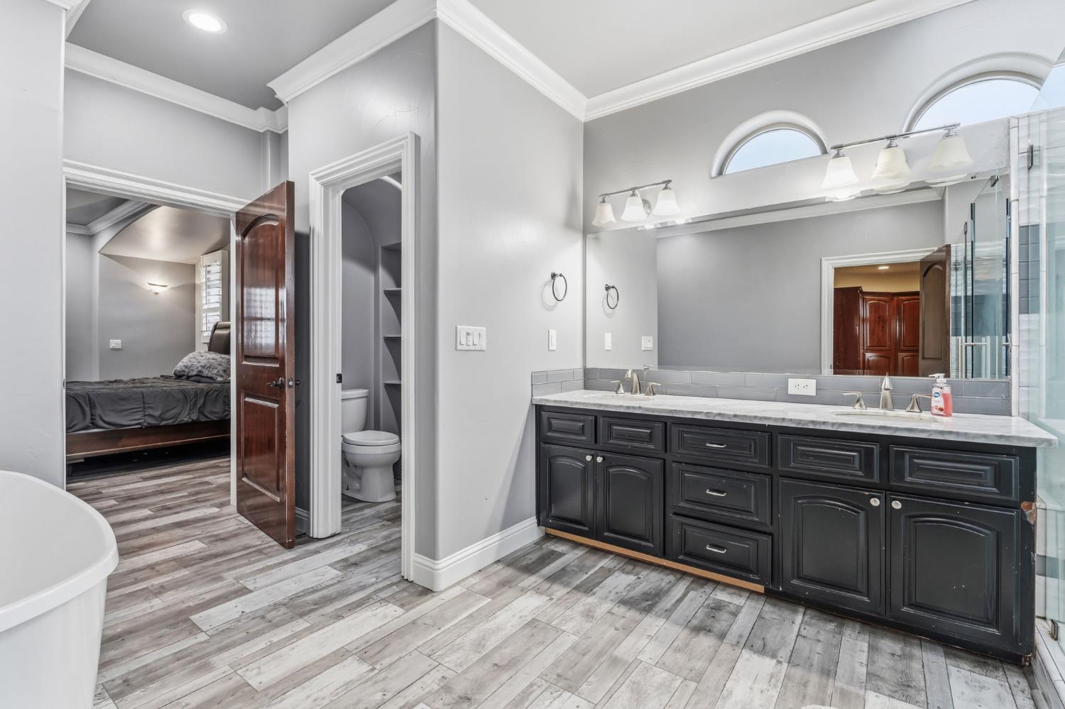 17703 El Camino Road Madera, CA 93636 - Photo 37 of 64 a spacious bathroom with a double vanity sink and a mirror