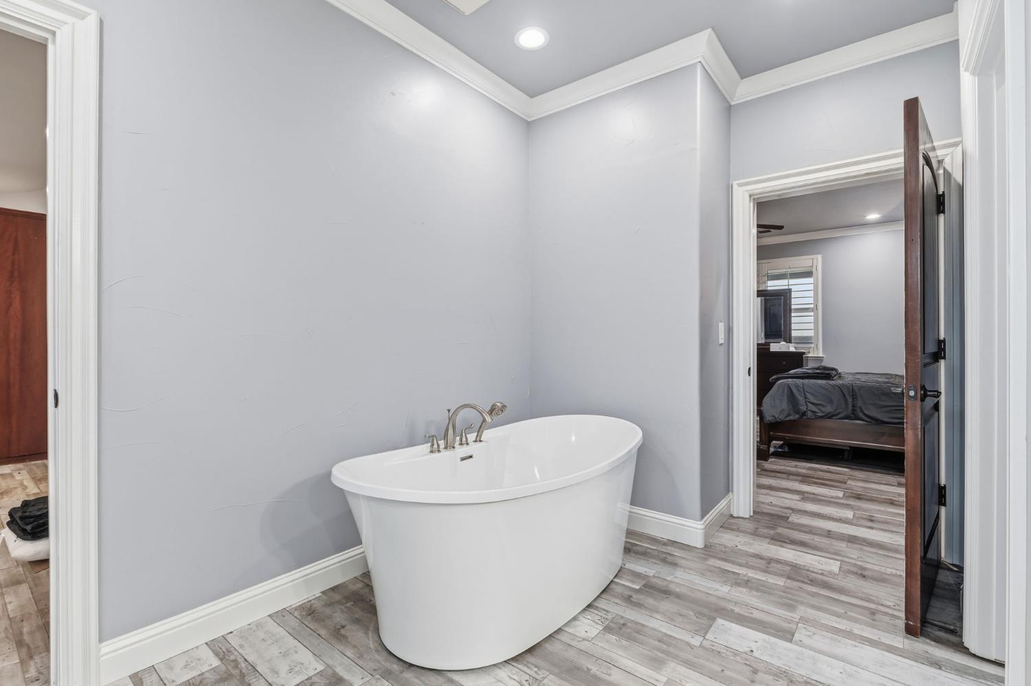 17703 El Camino Road Madera, CA 93636 - Photo 38 of 64 a bathroom with a bathtub and a sink