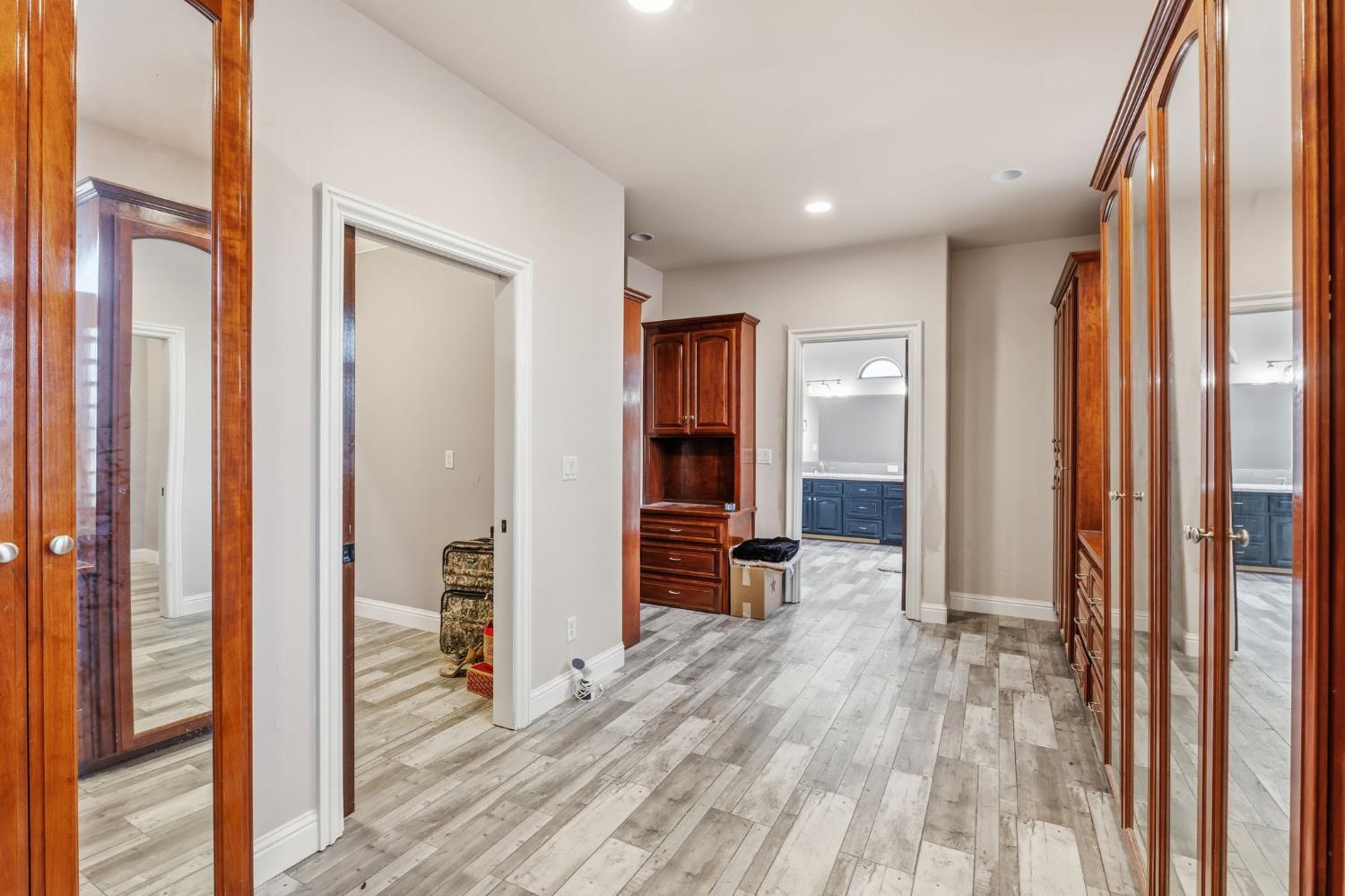 17703 El Camino Road Madera, CA 93636 - Photo 40 of 64 a view of a hallway with wooden floor and windows