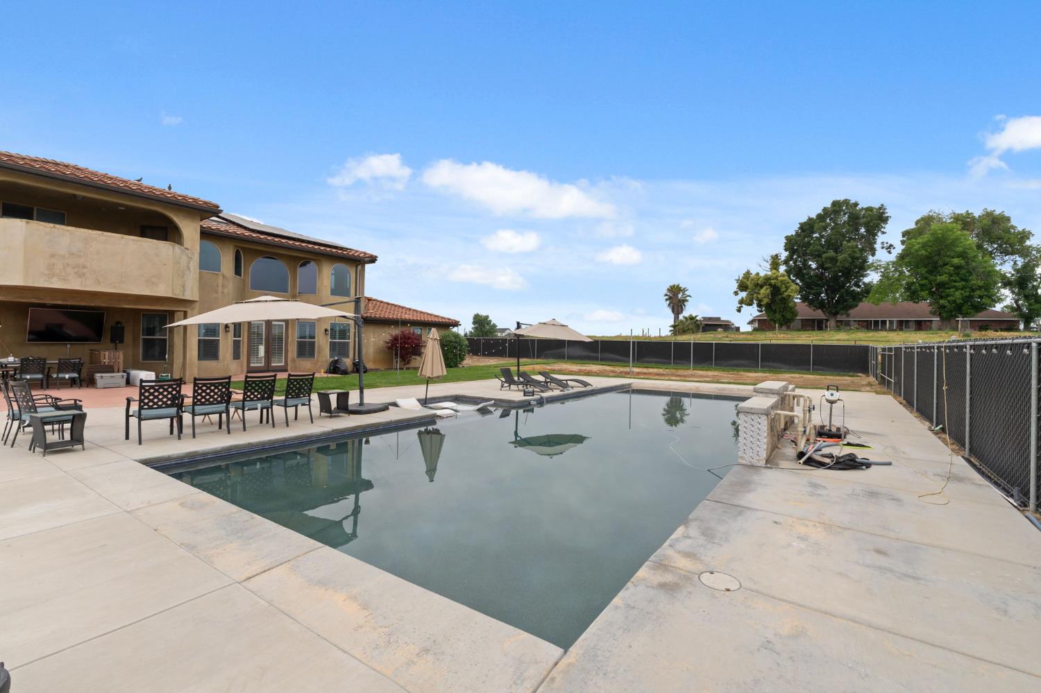 17703 El Camino Road Madera, CA 93636 - Photo 45 of 64 a view of a swimming pool with outdoor seating