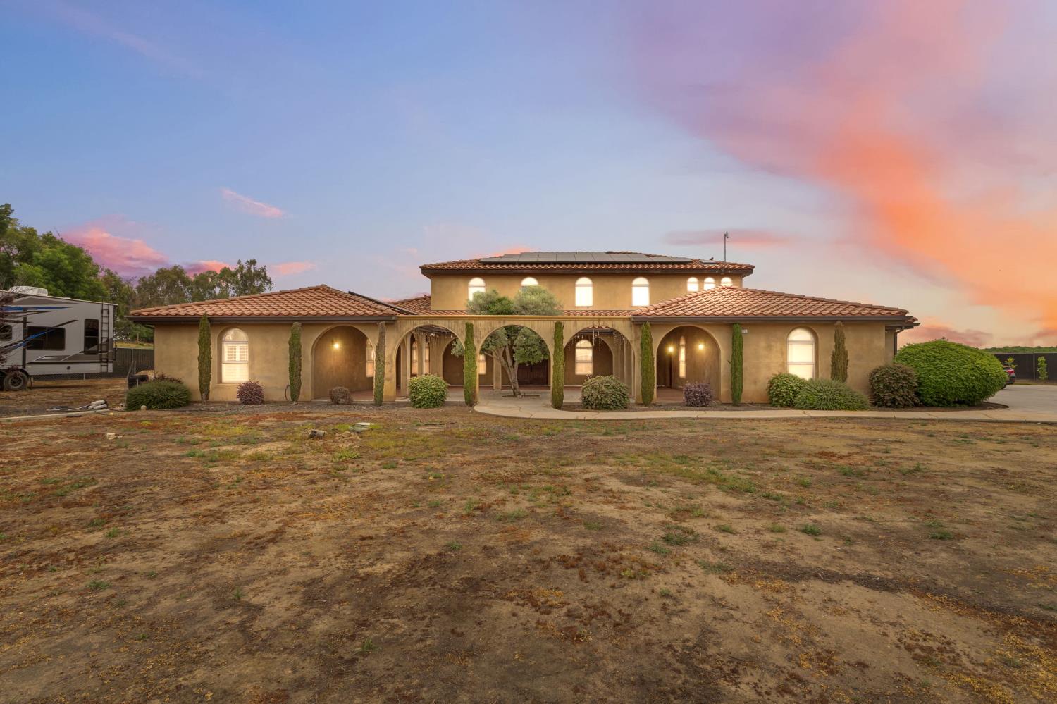 17703 El Camino Road Madera, CA 93636 - Photo 5 of 64 a front view of a house with garden