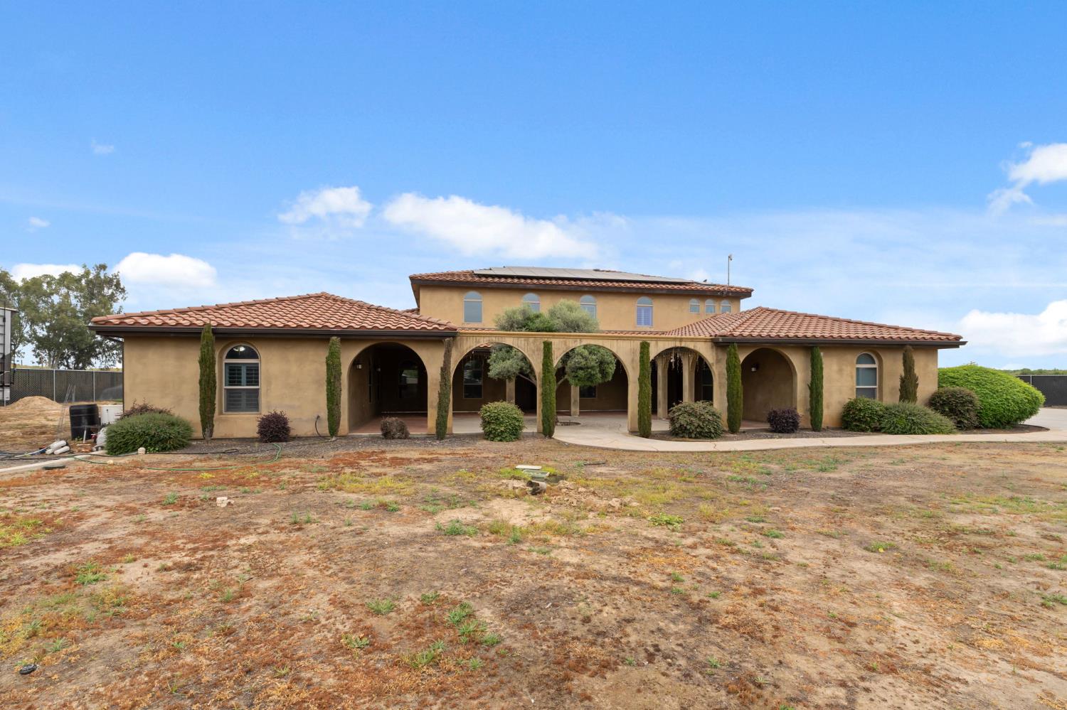 17703 El Camino Road Madera, CA 93636 - Photo 8 of 64 a front view of a house with a yard