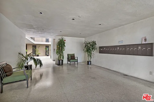 a view of a livingroom with furniture and a potted plant