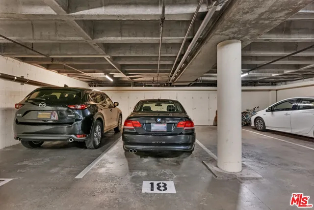 a view of parking garage with cars parked