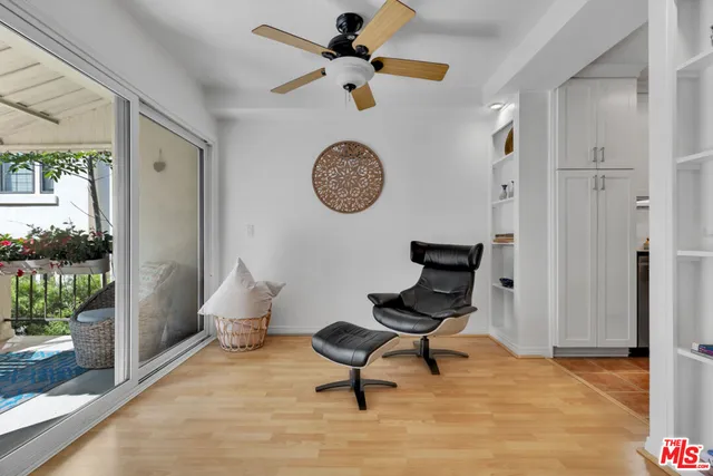 a view of workspace with wooden floor and a ceiling fan
