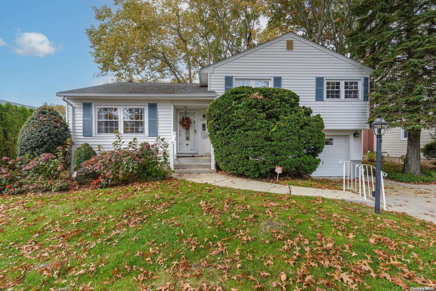 54 Russell Road Garden City, NY 11530 - Photo 1 of 1 front view of a house with a yard