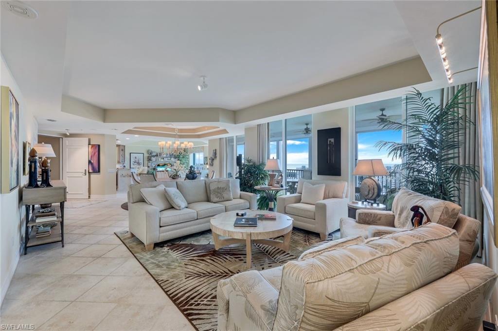 295 Grande Way, Unit 1202 Naples, FL 34110 - Photo 2 of 36 a living room with furniture and a large window