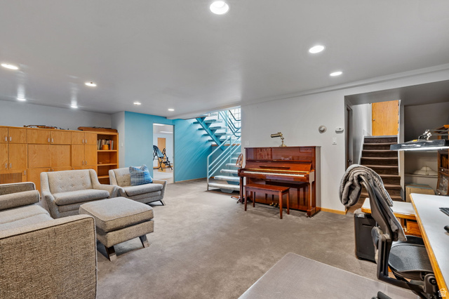 1856 Fort Canyon Road Alpine, UT 84004 - Photo 23 of 49 Carpeted room featuring recessed lighting, a built-in wooden storage unit with shelving, and a painted metal staircase with wood treads