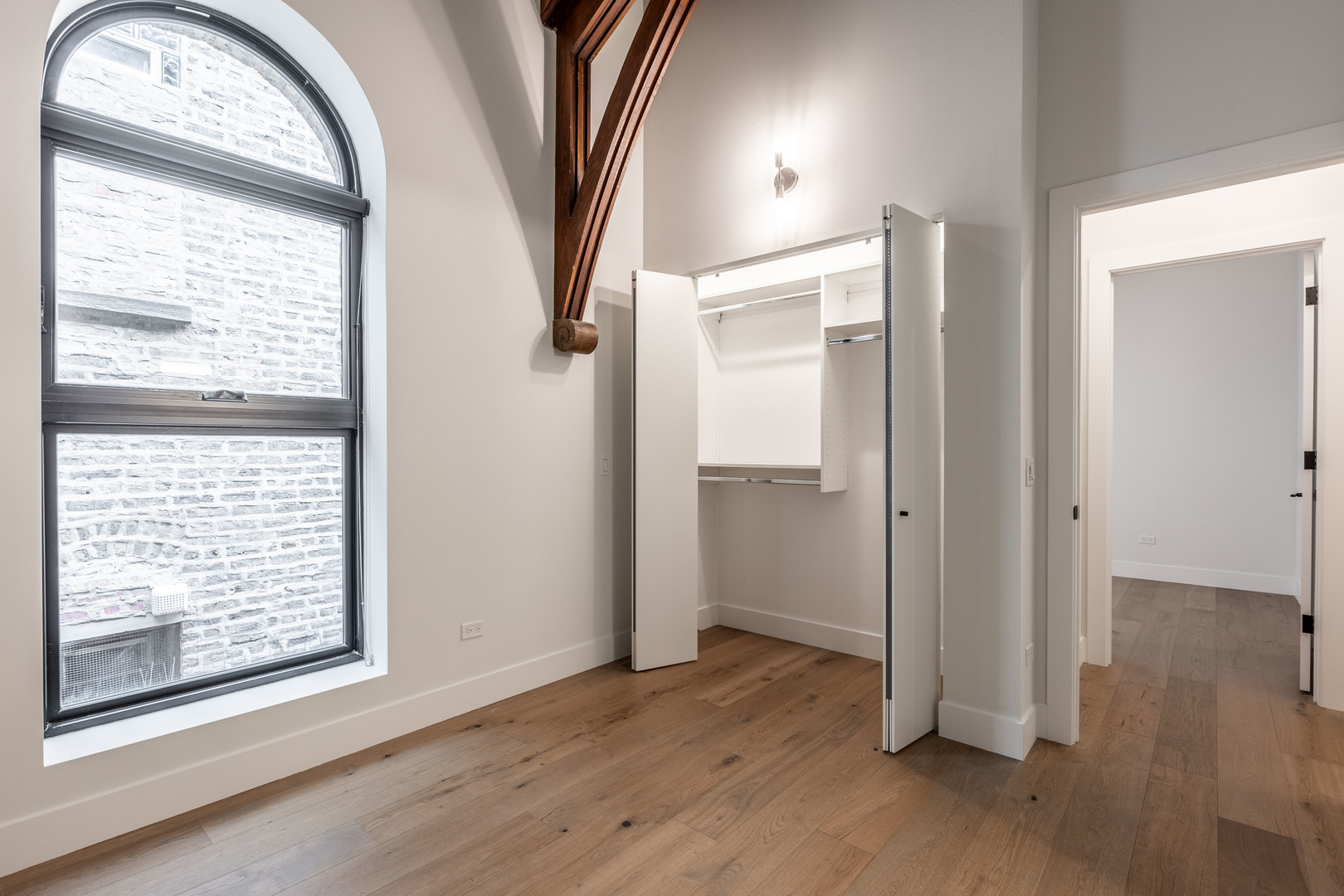 Undisclosed Address Chicago, IL 60647 - Photo 12 of 17 an empty room with wooden floor mirror and windows