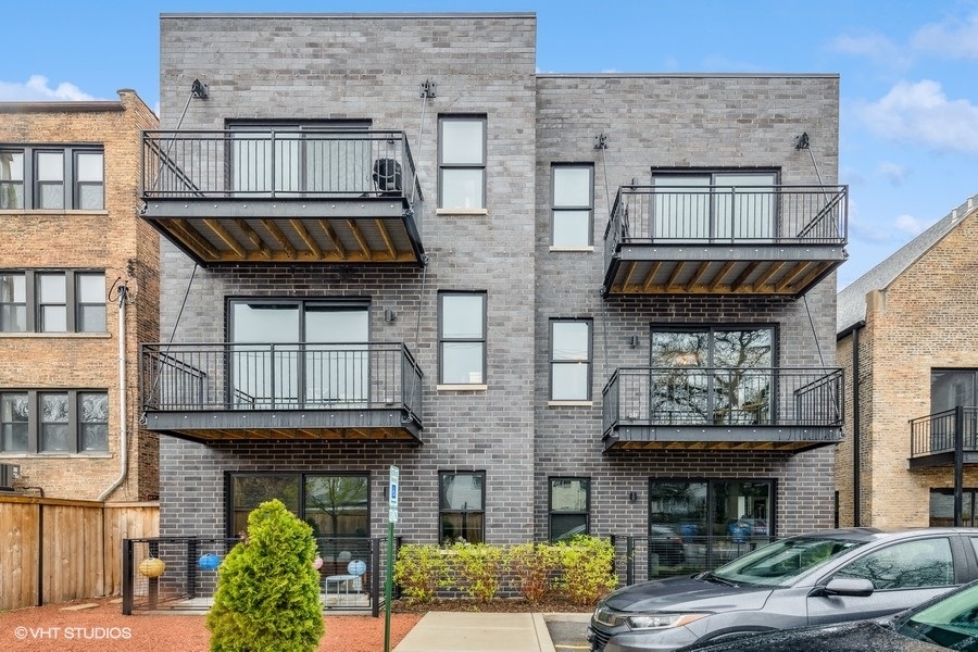 Undisclosed Address Chicago, IL 60647 - Photo 17 of 17 a front view of a building with a garden and plants