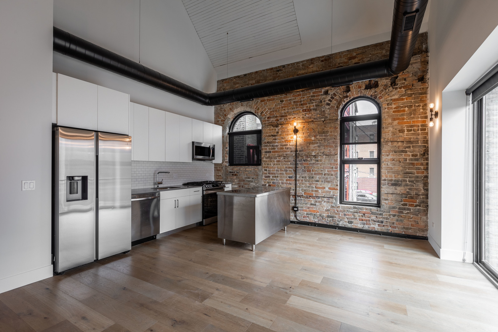 Undisclosed Address Chicago, IL 60647 - Photo 3 of 17 a kitchen with stainless steel appliances granite countertop a refrigerator a sink a stove and oven with wooden floor