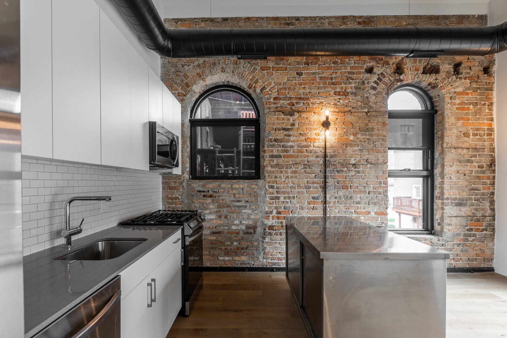 Undisclosed Address Chicago, IL 60647 - Photo 4 of 17 a kitchen with stainless steel appliances granite countertop a stove and a sink