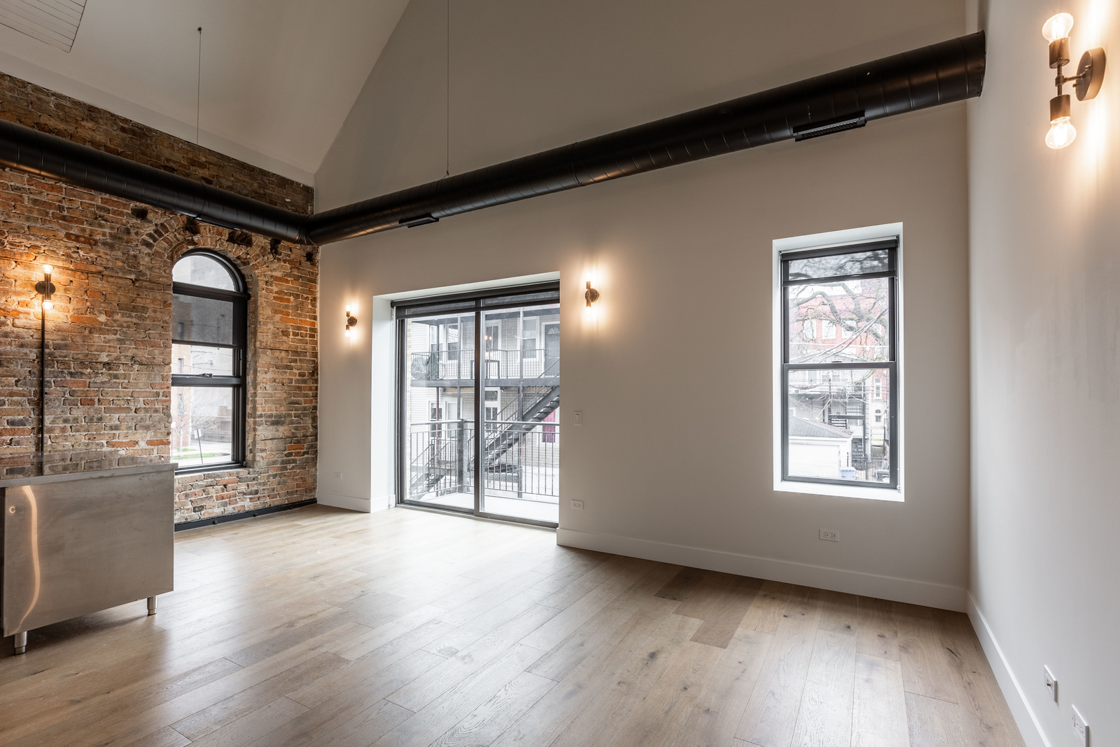 Undisclosed Address Chicago, IL 60647 - Photo 8 of 17 a view of an empty room with a window and wooden floor