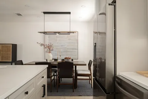 a view of a dining room with a table and chairs
