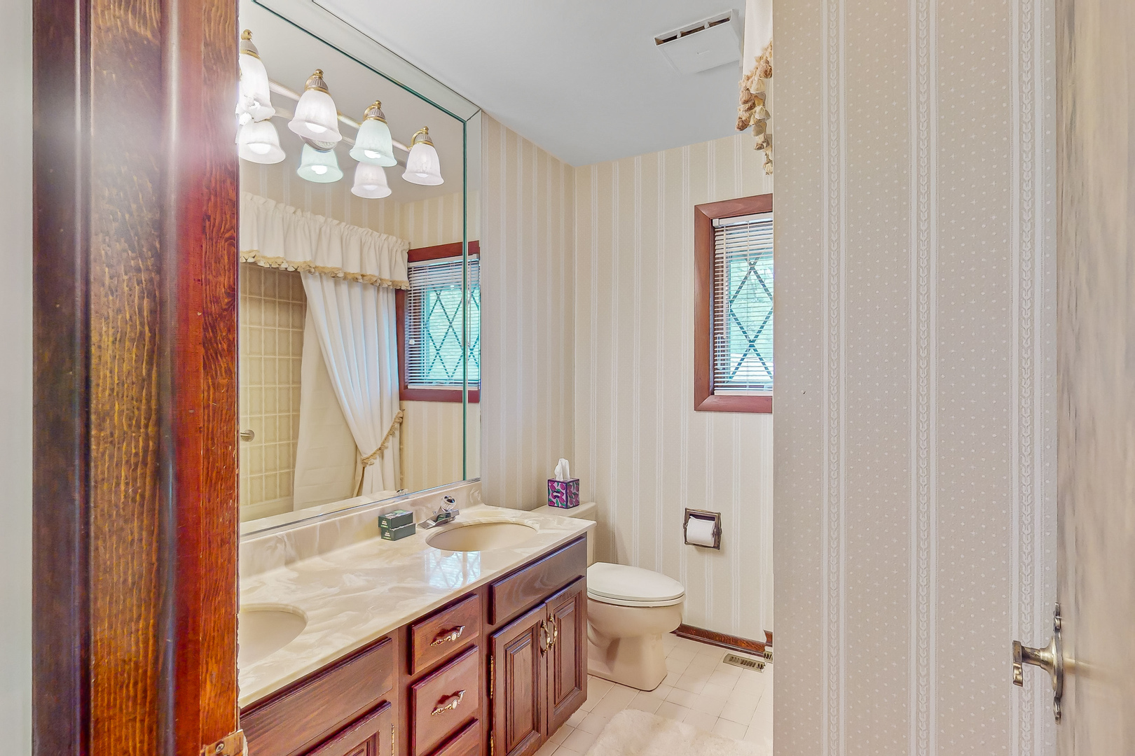 309 Hambletonian Drive Oak Brook, IL 60523 - Photo 13 of 39 a bathroom with a granite countertop sink a toilet and a mirror