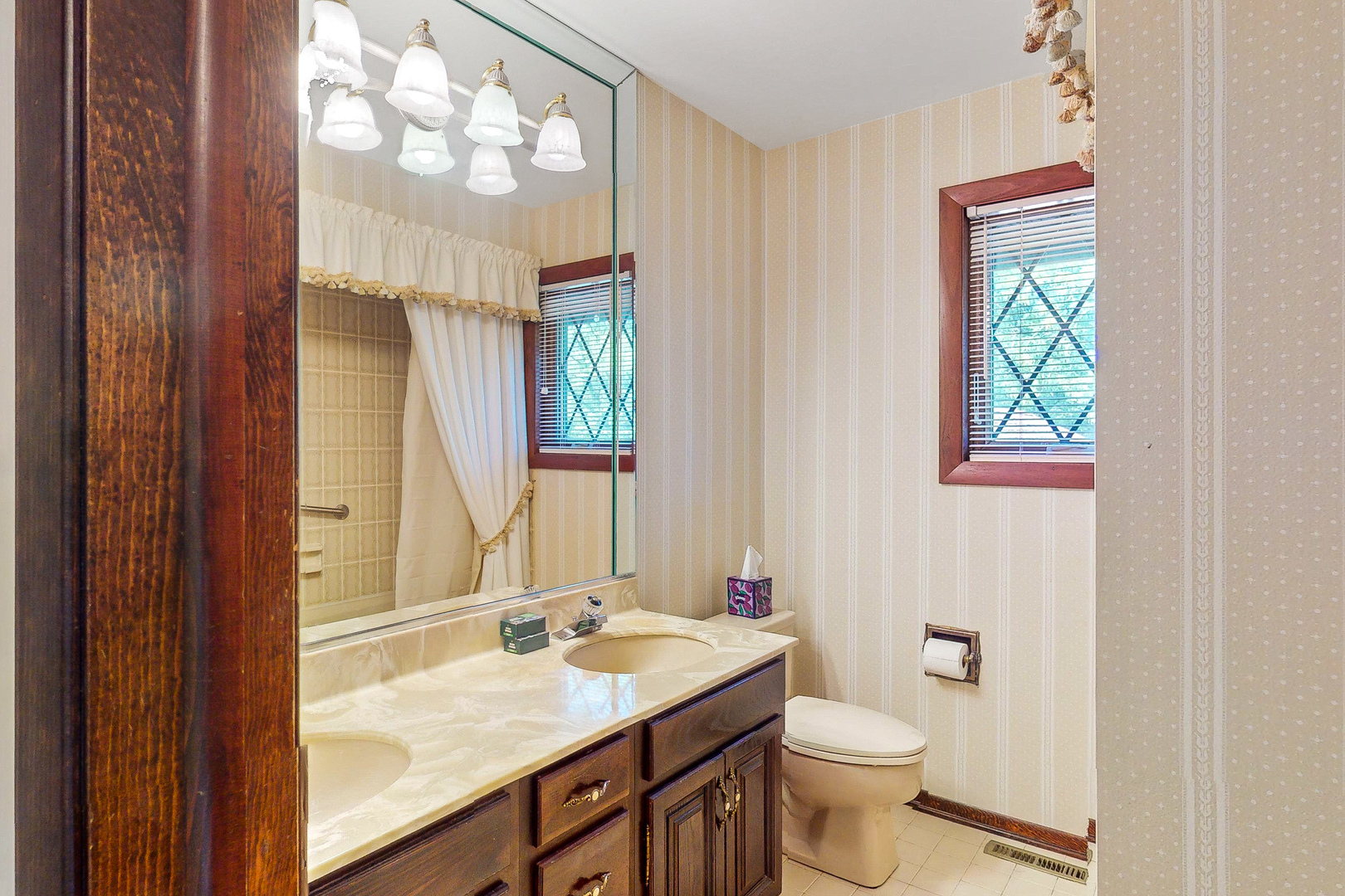309 Hambletonian Drive Oak Brook, IL 60523 - Photo 25 of 39 a bathroom with a granite countertop toilet a sink and a mirror
