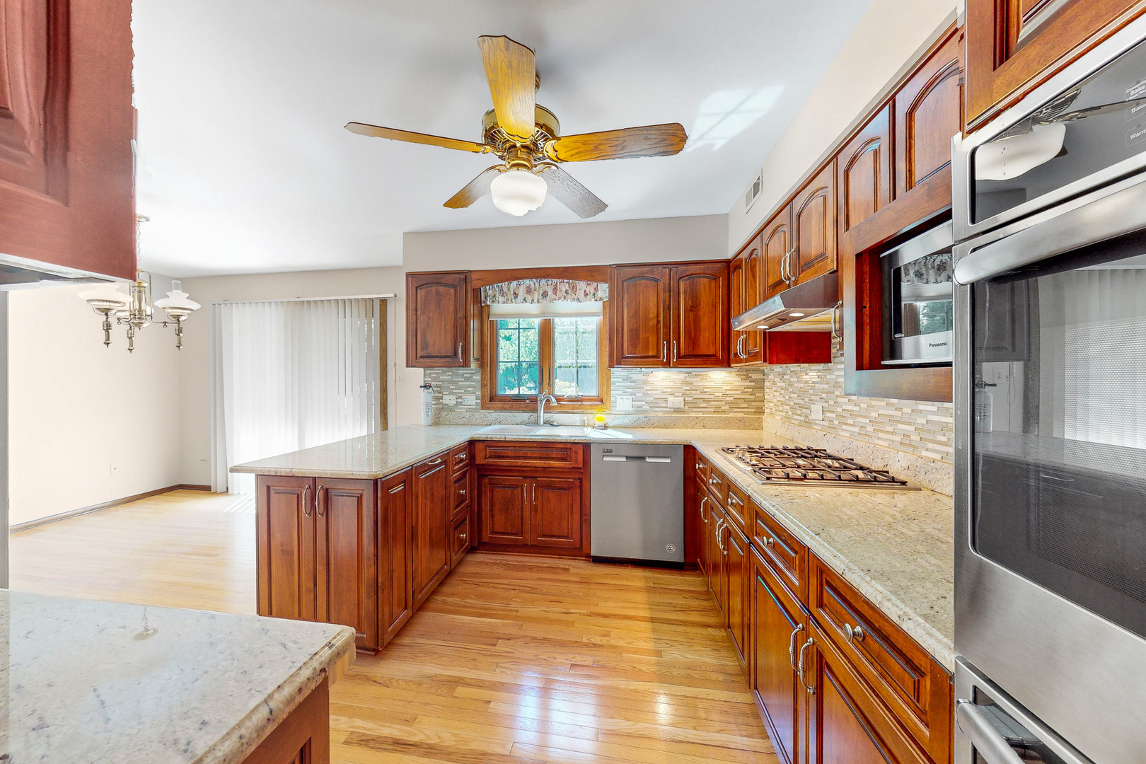309 Hambletonian Drive Oak Brook, IL 60523 - Photo 4 of 39 a kitchen with stainless steel appliances granite countertop a sink and stove