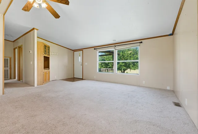 an empty room with windows and closet