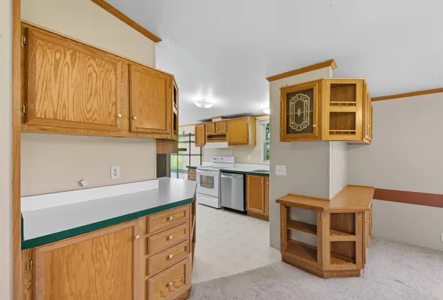 a kitchen with granite countertop a sink cabinets and oven